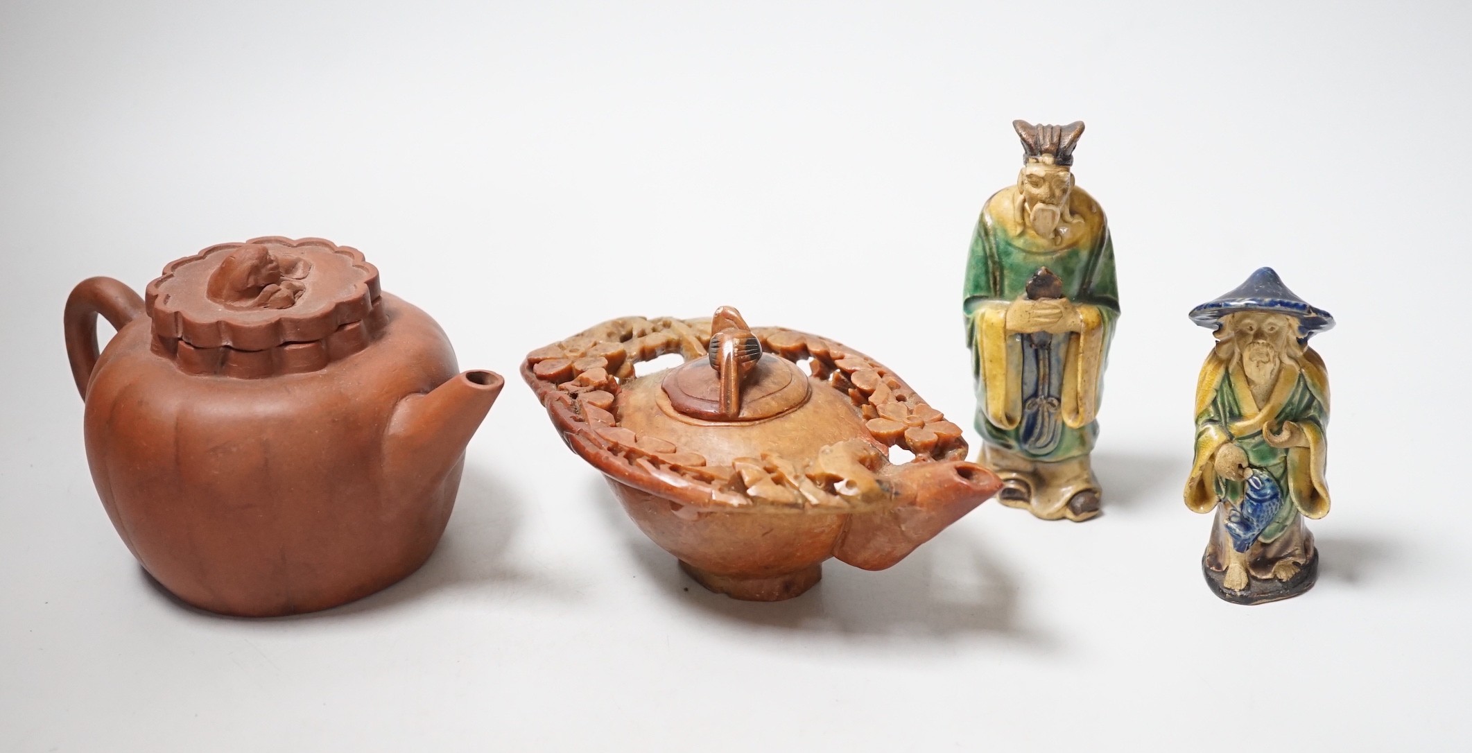 A Chinese carved soapstone pot, a terracotta teapot, and two earthenware figures, tallest figure 11cms high